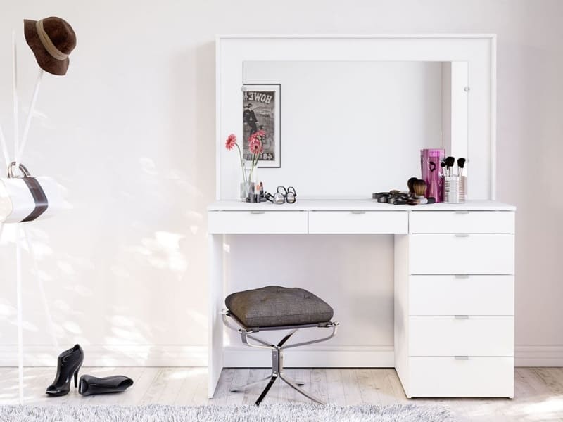 A classy white-colored vanity design with a big mirror, good storage space, and a matching stool, in a white room.