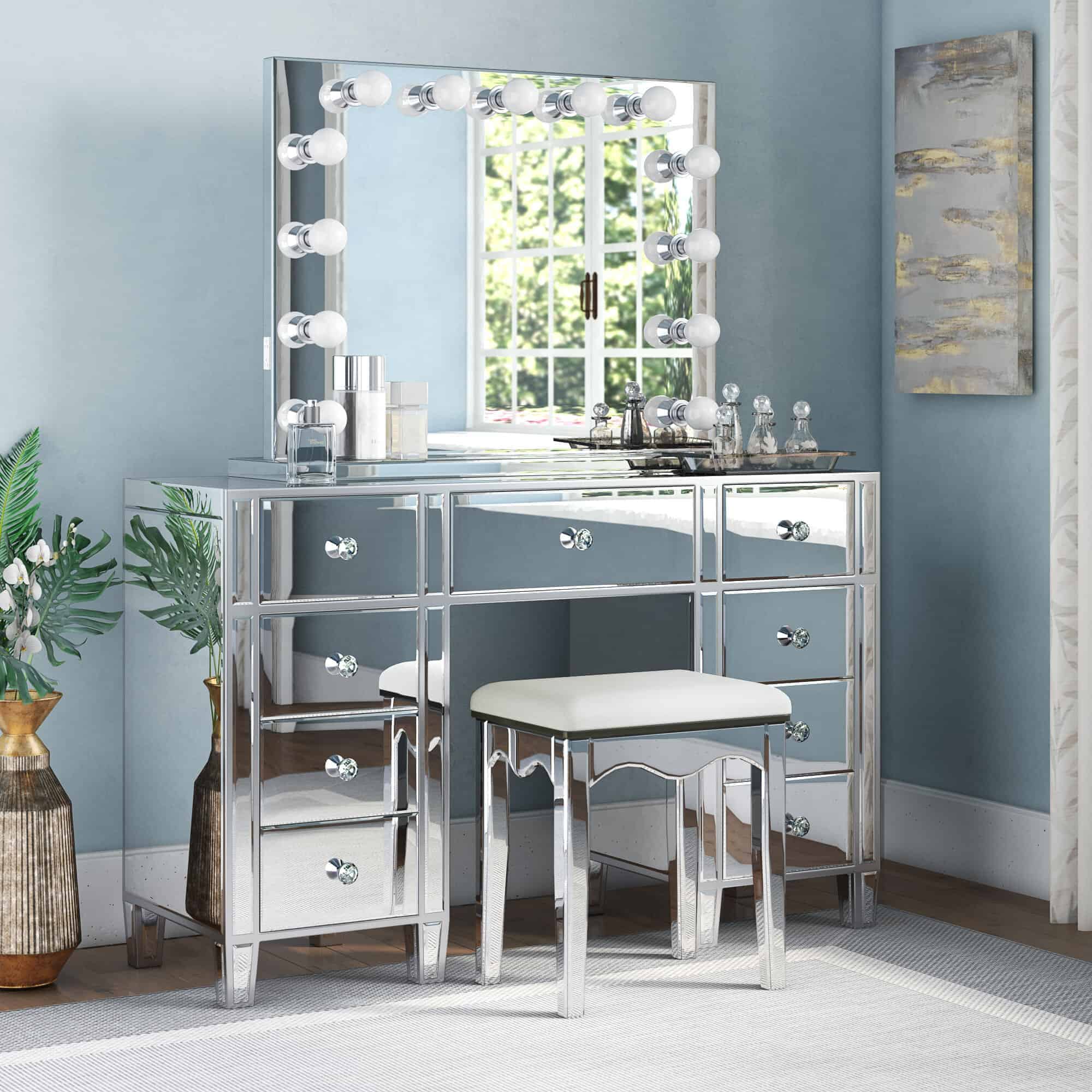 A stylish glass dressing table design with a big square mirror, lots of storage space, and a matching stool, in a blue room.