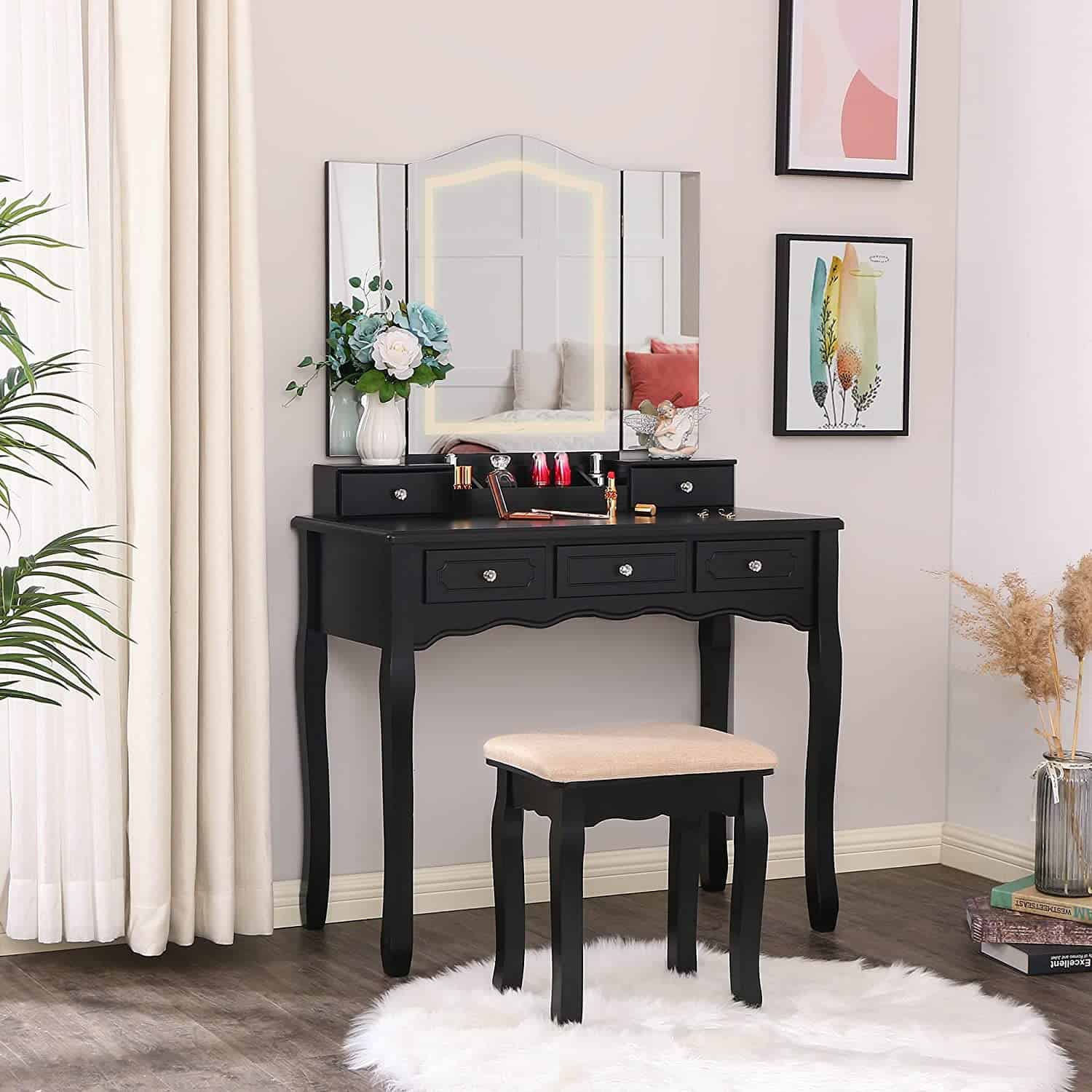An attractive black-colored dressing table design with a 3-fold mirror, minimum storage space, and a matching stool, in a white room.