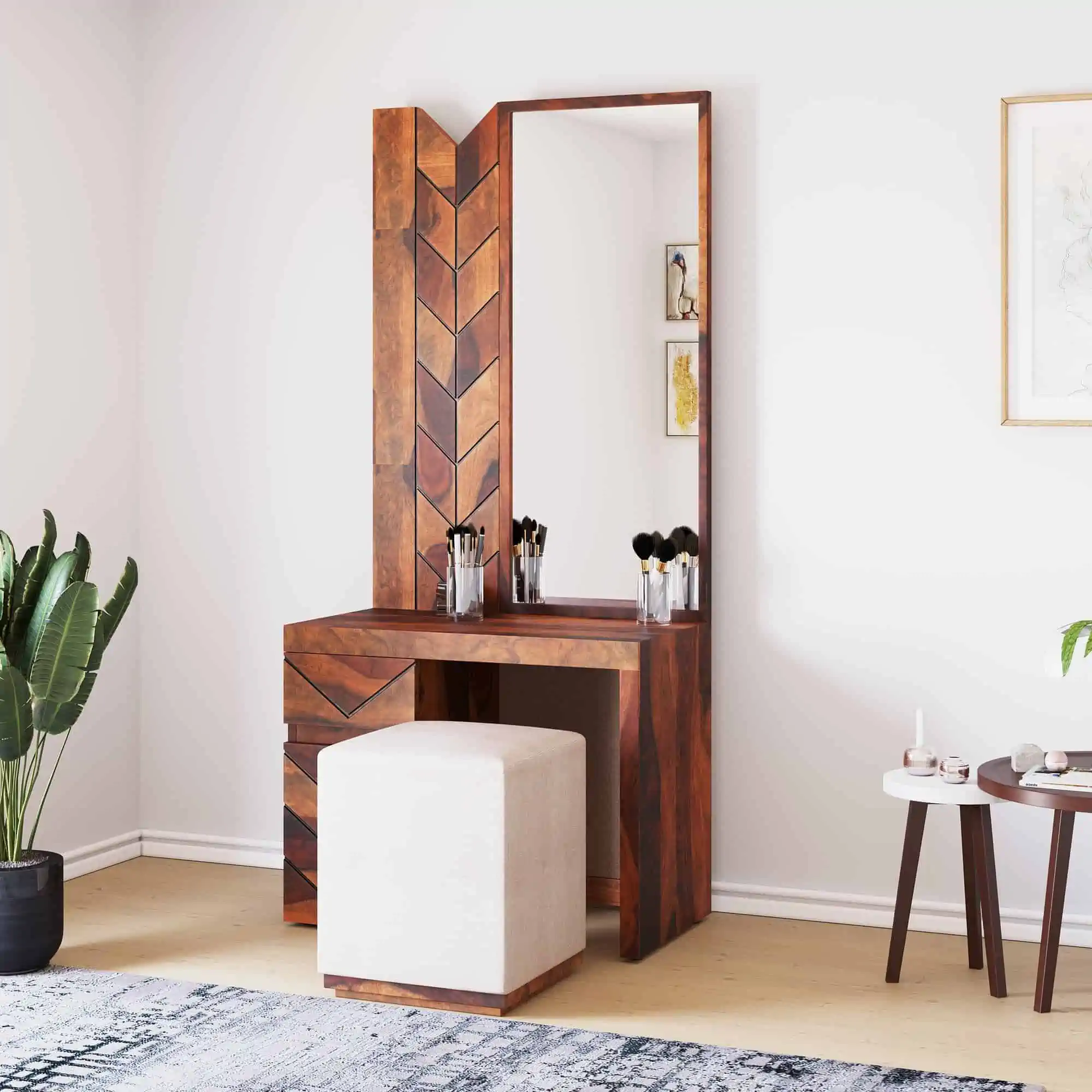 A pretty wooden dresser with a rectangular mirror, minimum storage and a matching stool, in a white room.