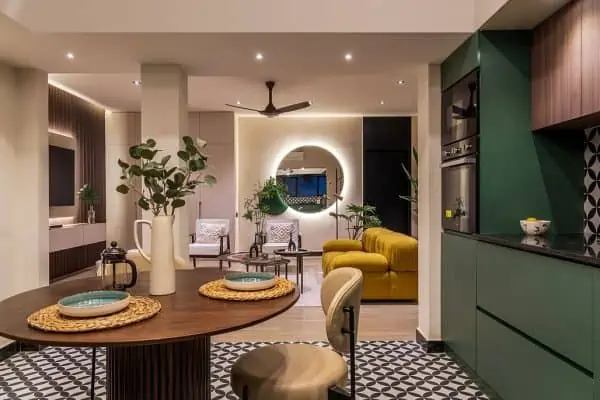 living room with brown table and chair and yellow sofa, mirror with light strip and a fan, home by the best and top interior designers in chennai