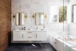 Beautiful bathroom vanity space with twin mirrors and wall mounted lighting fixtures