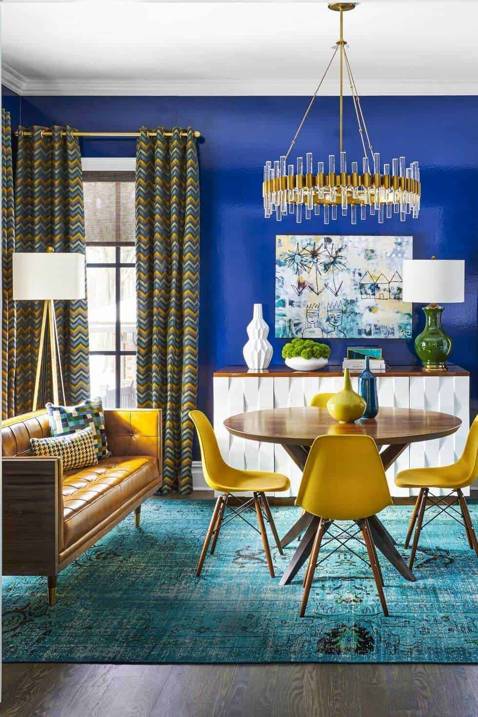 Blue dining room with wood table and yellow chairs