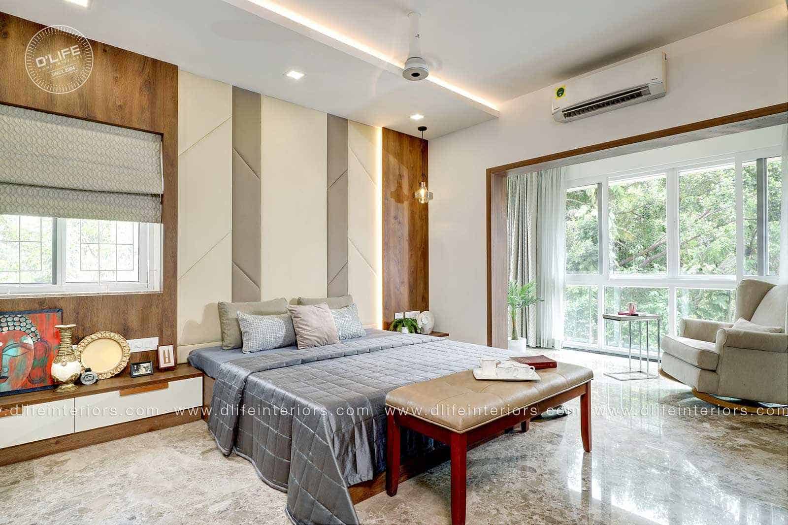 bedroom with a bed, fan, sofa, side table in white and brown and windows