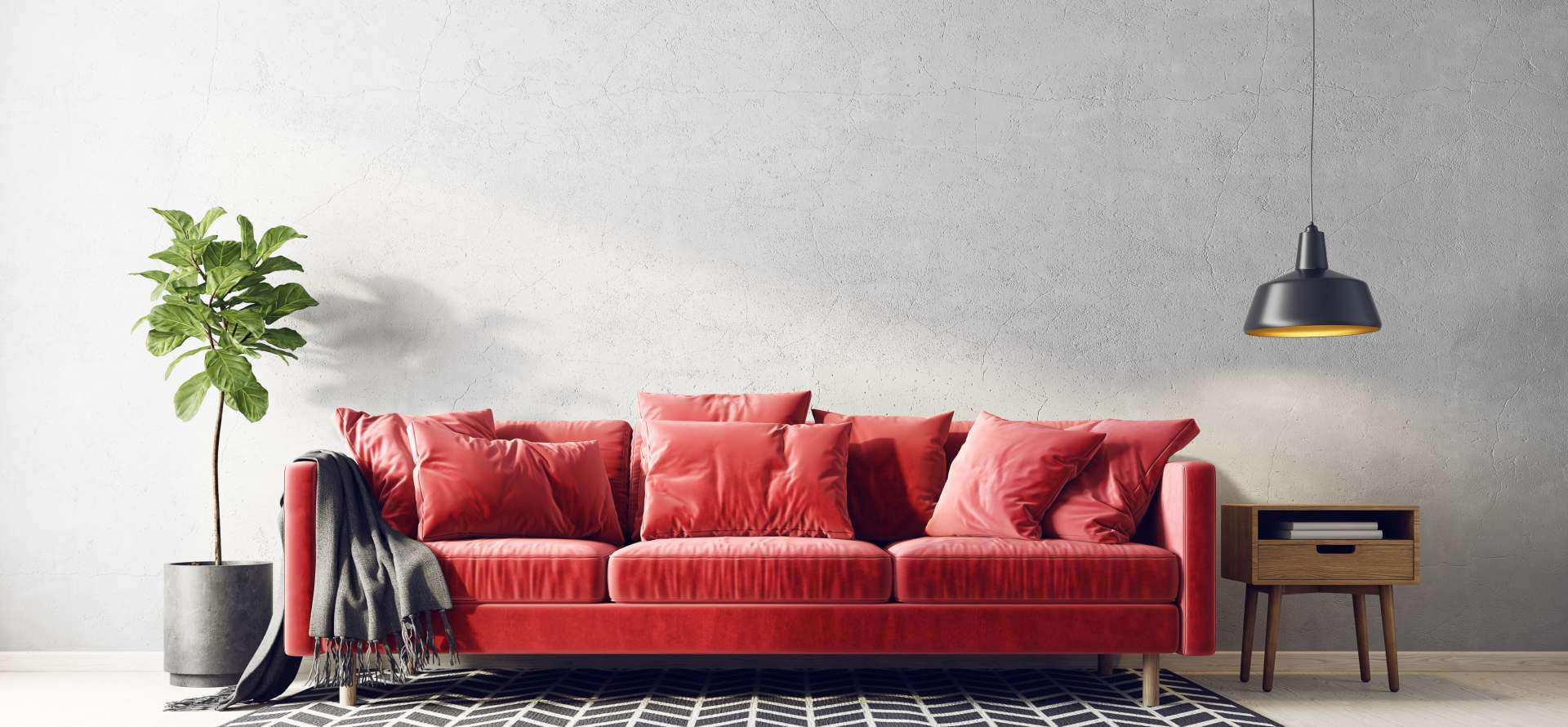 red couch in a living room with a rug, lamp and indoor plant