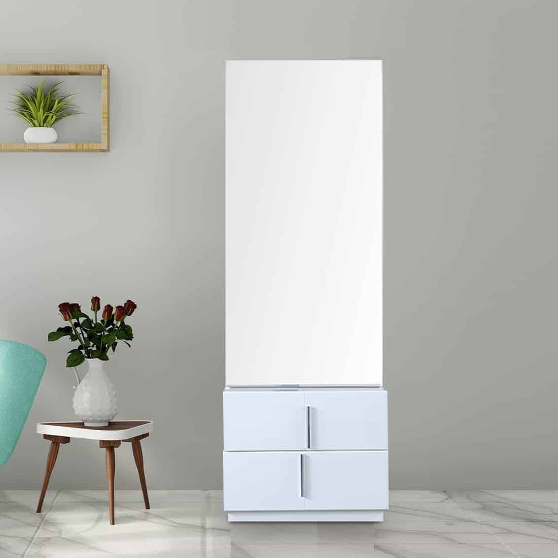 A simple white-colored white dresser with a rectangular mirror and minimum storage space, in a white room.