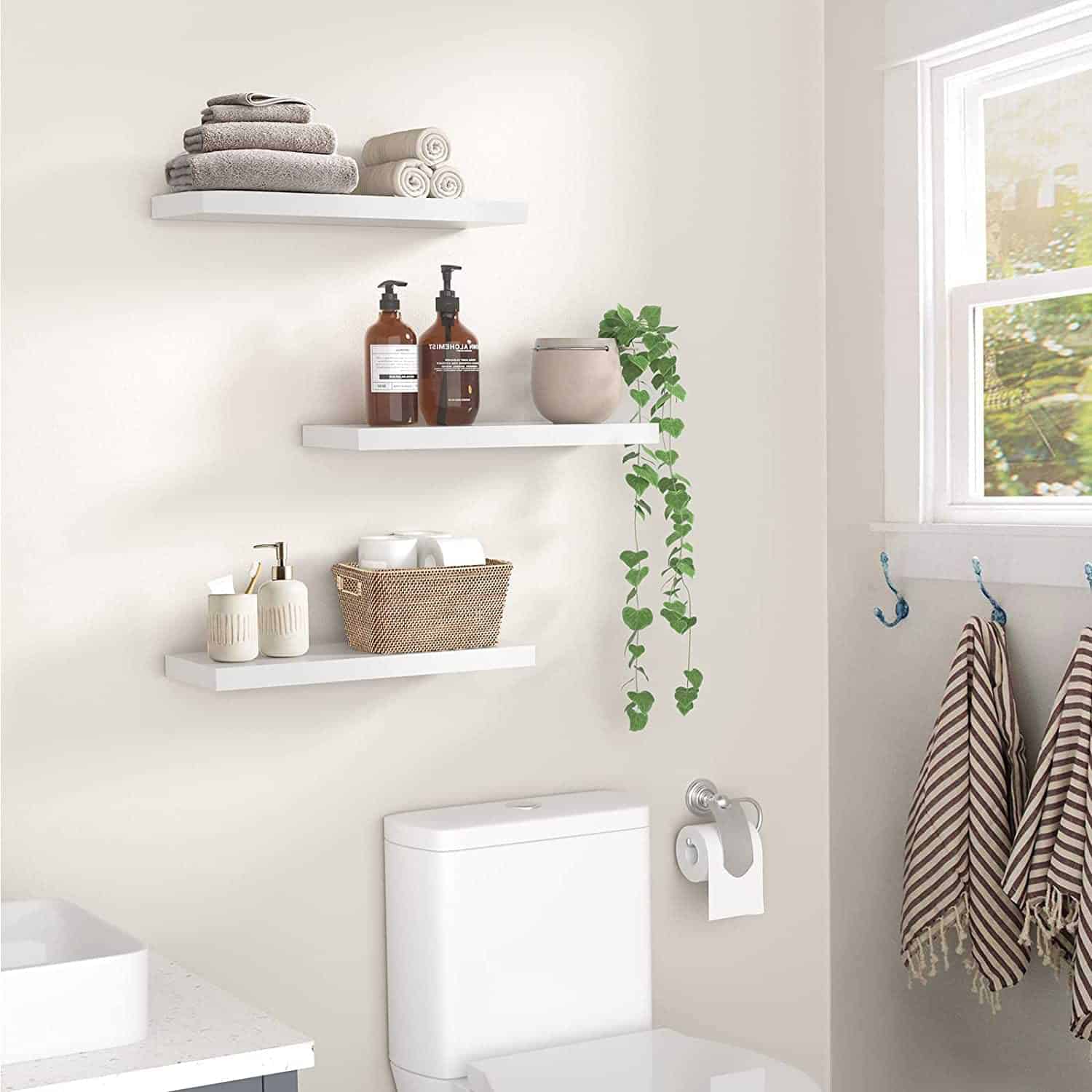 White floating shelves in bathroom for storing toiletries