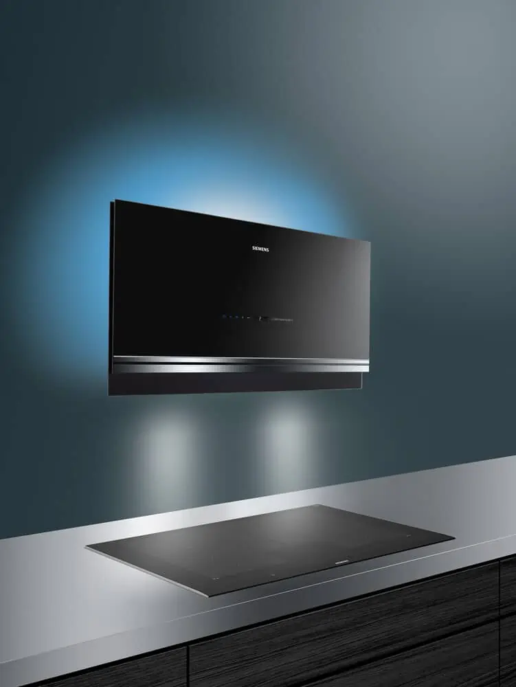 black coloured siemens wall mounted straight kitchen hood, siemens studioline chimney with blue emotion light and connected hob