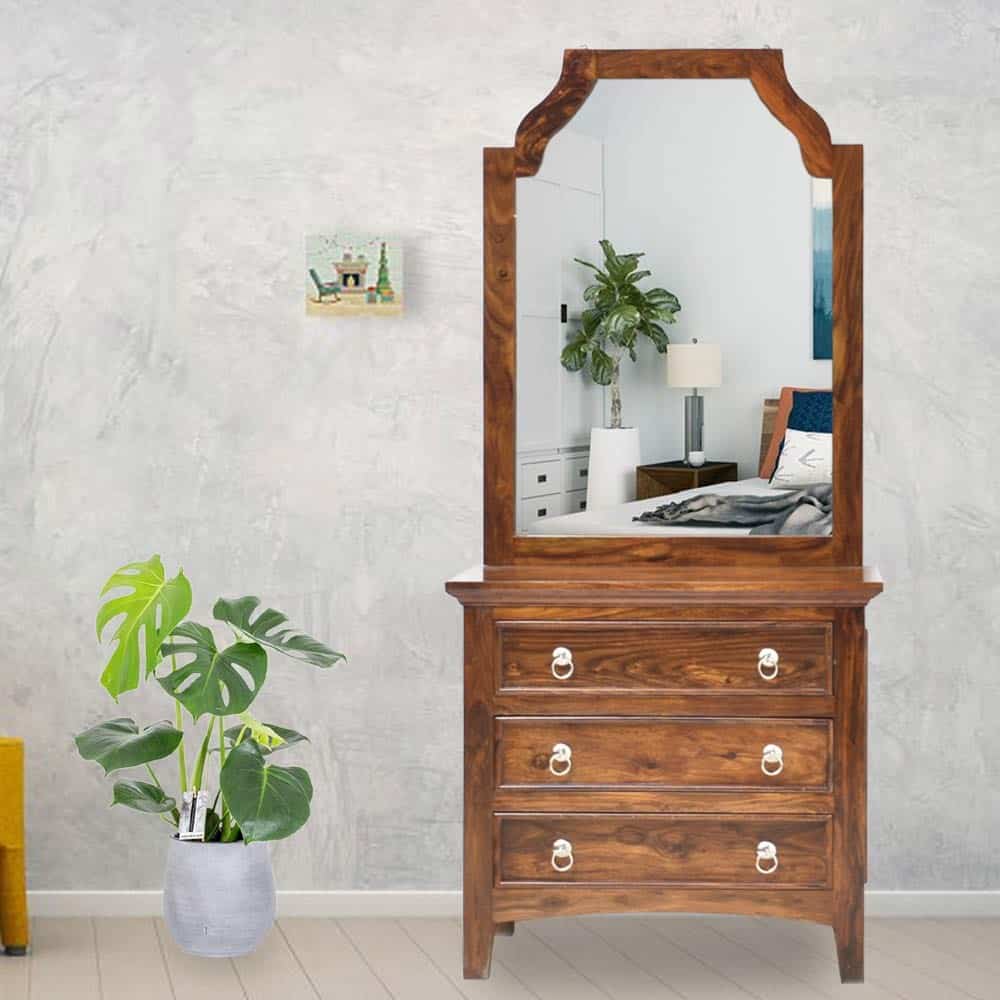 A pretty dressing table design with a big mirror and good storage space, in a room with minimum decor.