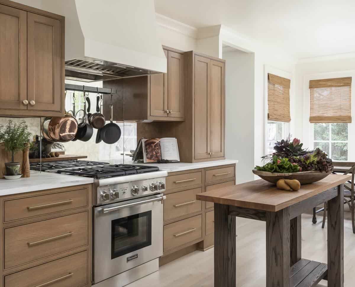 An elegant brown-stained cabinetry in a white kitchen area.