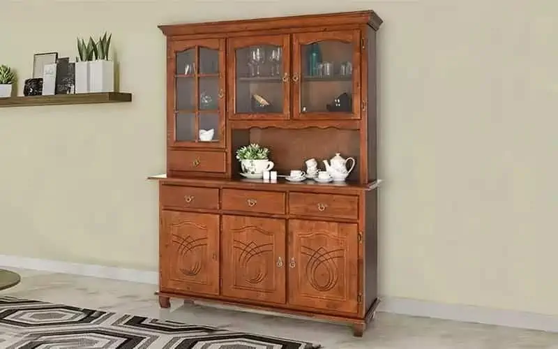 A graceful wooden standalone kitchen cabinet in a grey interior.