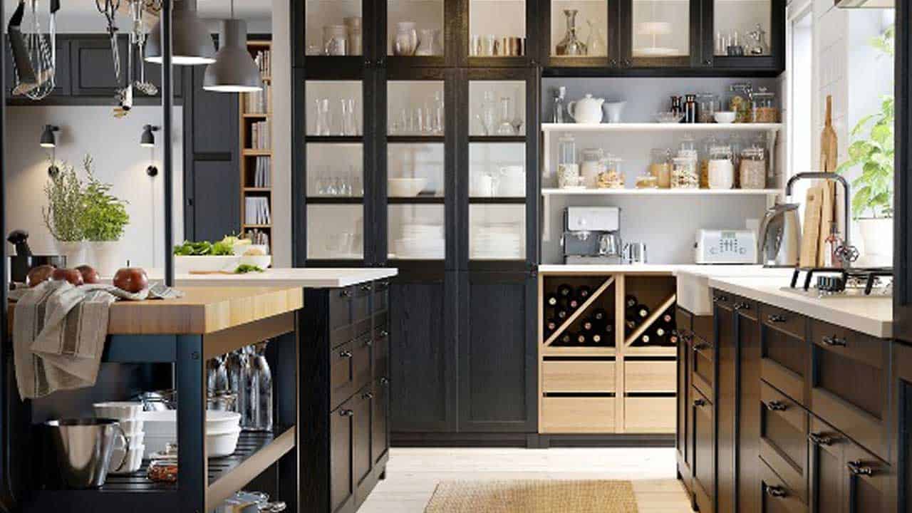 An elegant black-colored tall kitchen cabinet in a small kitchen area.
