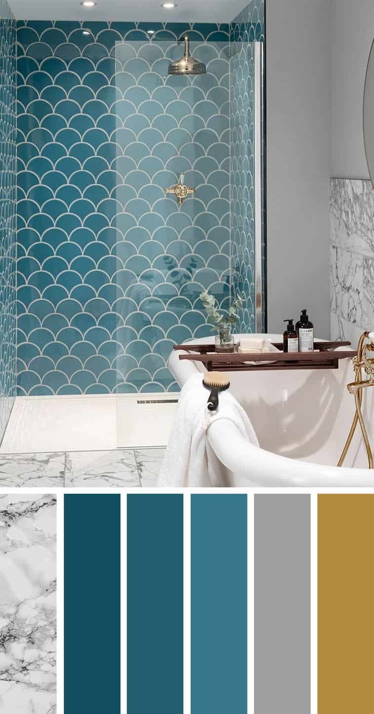 Home colours of a bathroom with blue tiled walls, a marble bathtub and gold shower fittings