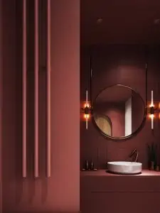 vessel vanity in a maroon luxe bathroom with mirror and scone lights