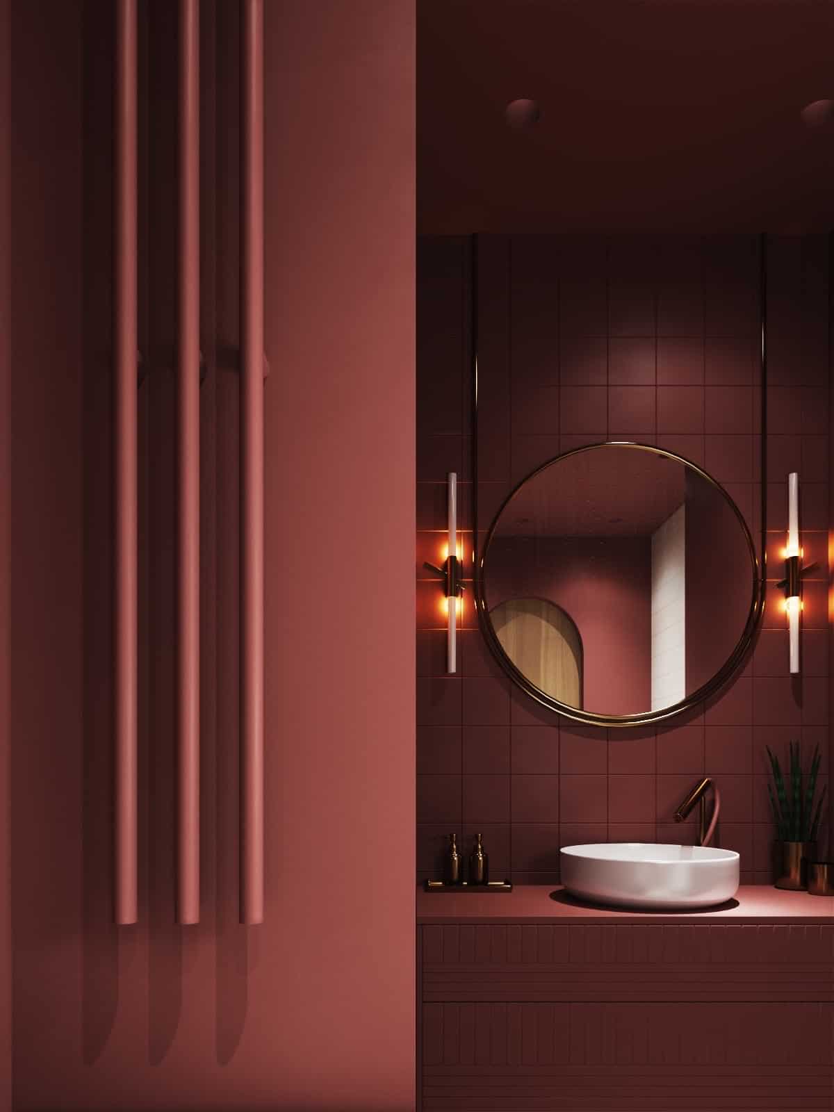 vessel vanity in a maroon luxe bathroom with mirror and scone lights