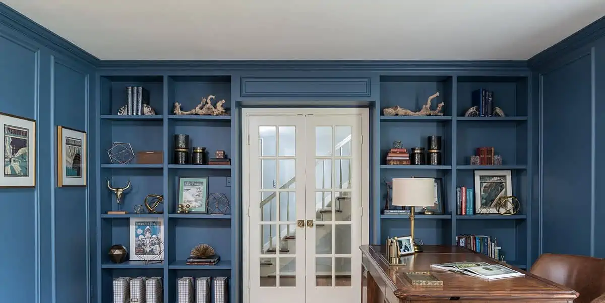 Blue wall with inbuilt wall shelves for display