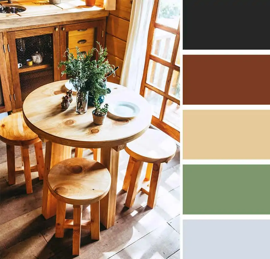 A rustic and homely dining area with a round wooden dining table with green flowers