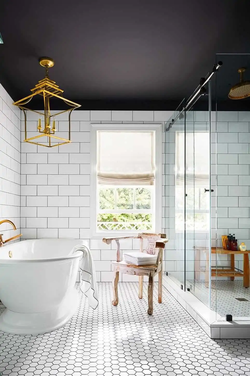 Golden modern chandelier in bathroom with window