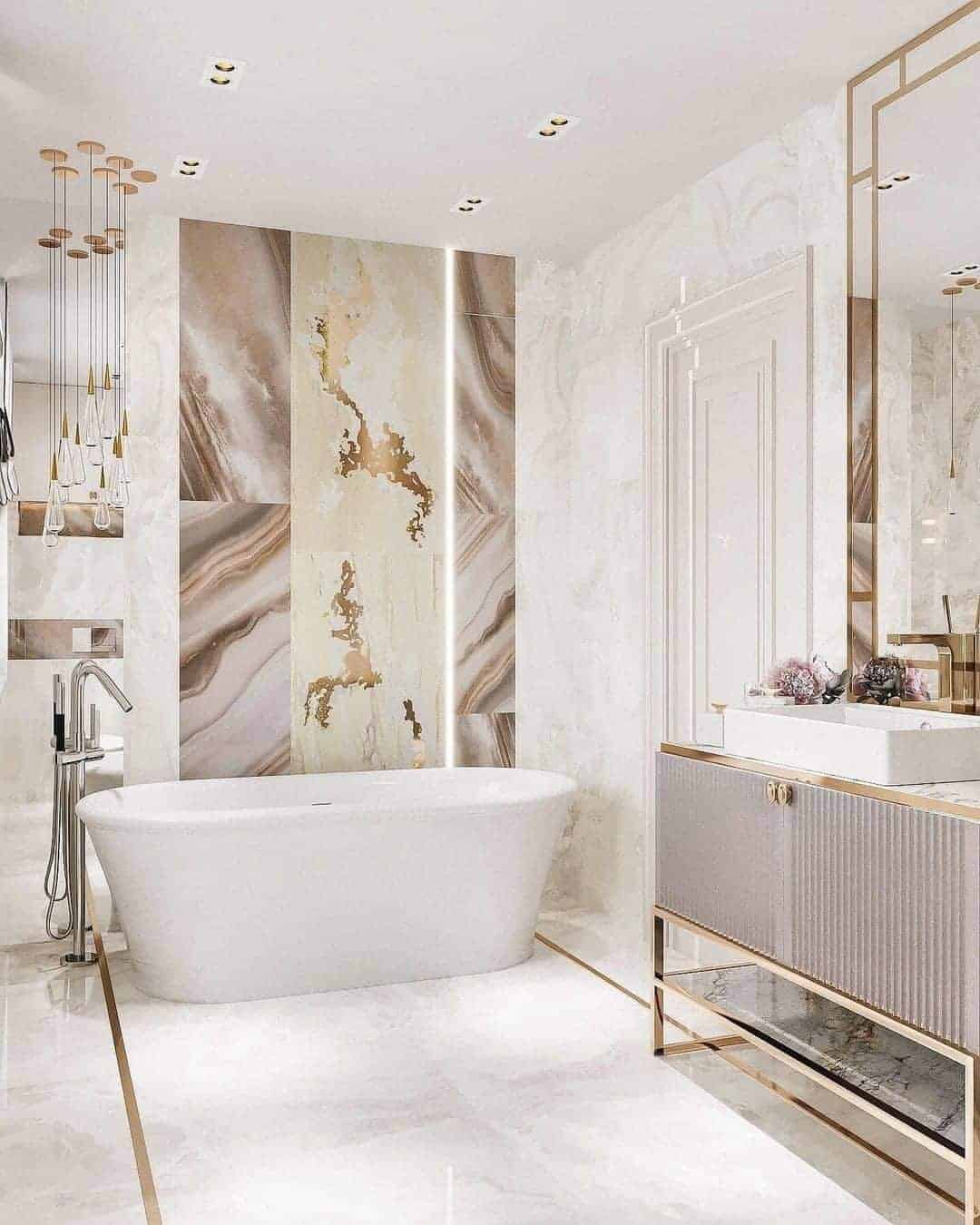 a white, golden and brown marble bathroom with bathtub and wash basin sink