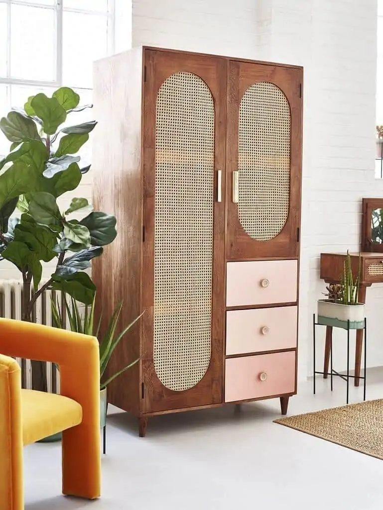 rattan modern cupboard/wardrobe design in brown with pink drawers witth a yellow chair and indoor plant