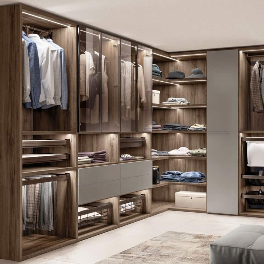 brown closet with glass doors, rug, clothes and seating arrangement