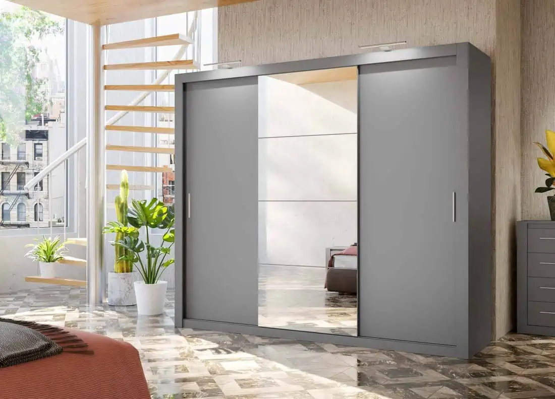 a grey closet with mirrors and an indoor plant