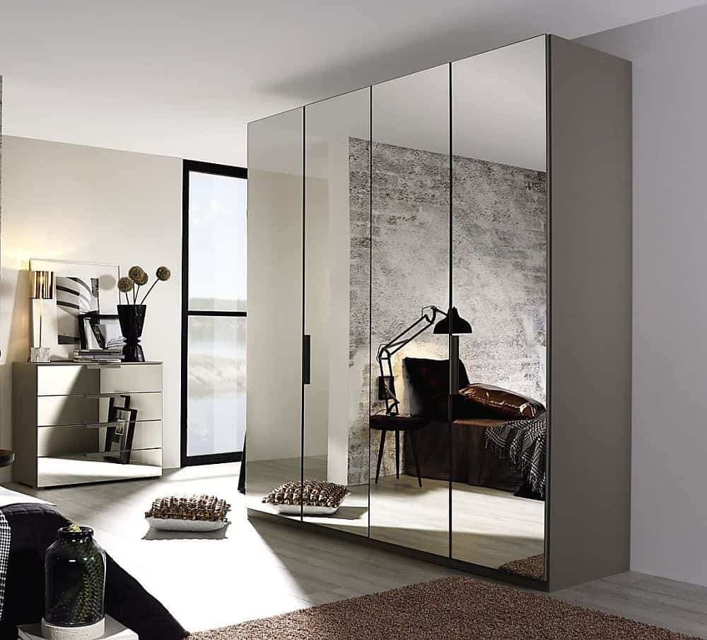 a closet with mirrors in a white room with a rug and a cabinet