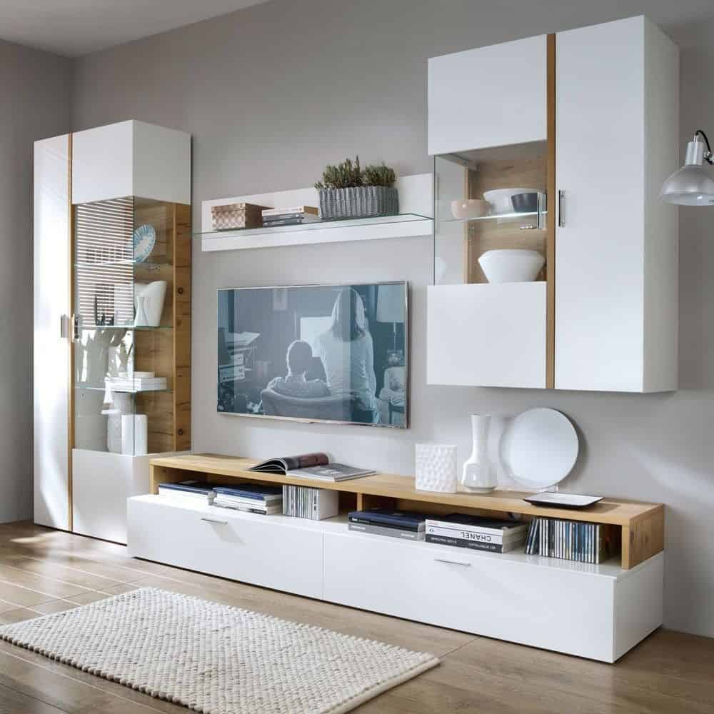 white cupboard with a tv unit compartment with decoartive accessories and a rug