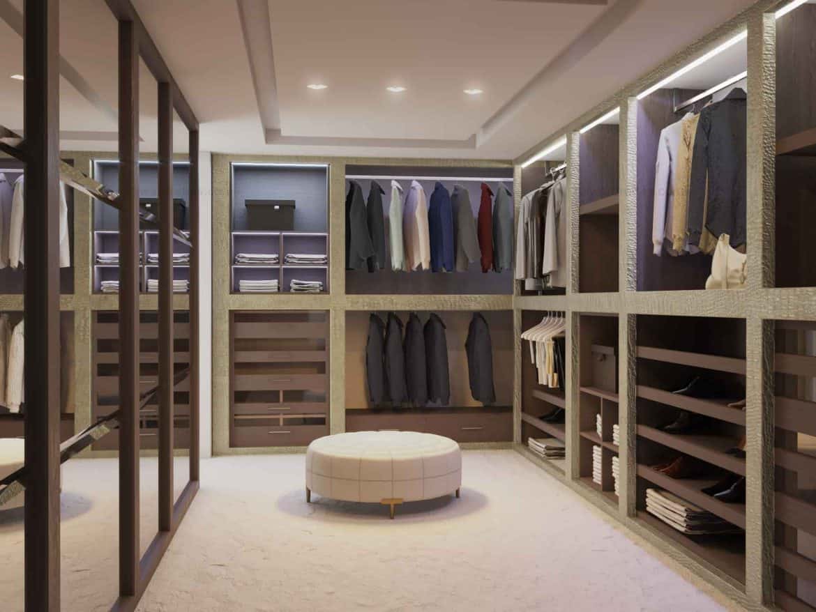 walk in closet with acloset, glass doors, white rug, seating arrangement and lights