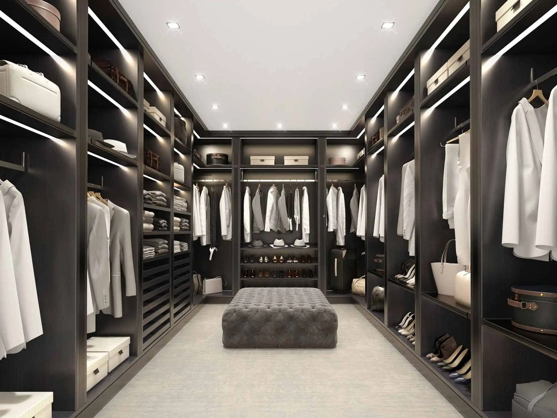 walk in closet with brown closet, glass doors, rug, seating arrangement and lights