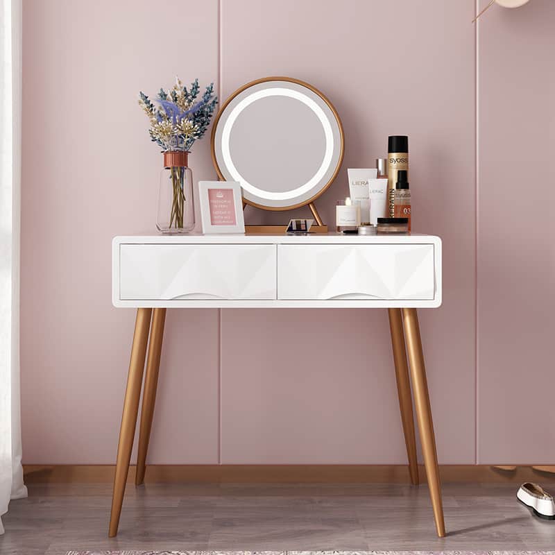 A minimalist white-color vanity design with minimum storage space, round mirror, and ring light in a pink room.