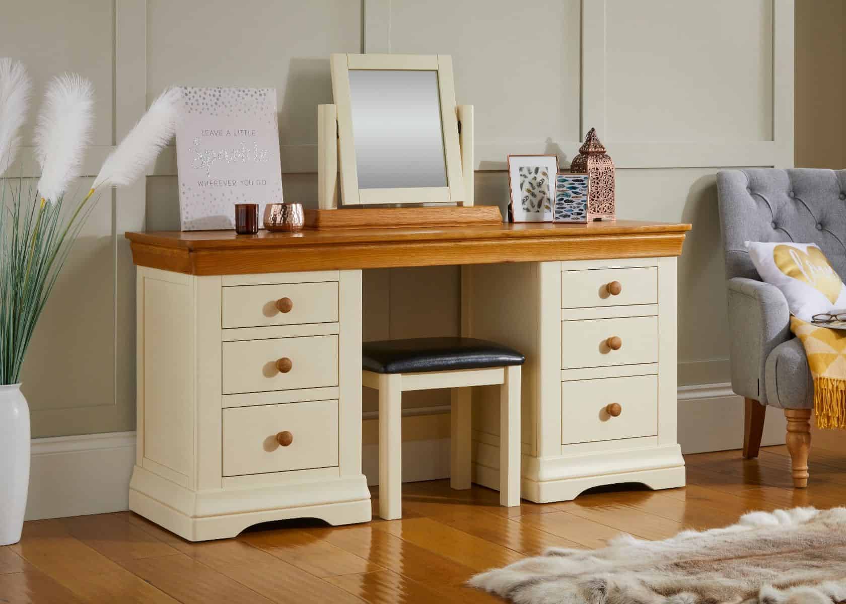 A white-color sturdy vanity design with a small square mirror and lots of storage drawers in a room.
