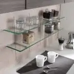 Pin shelf by salice made of glass placed on kitchen wall