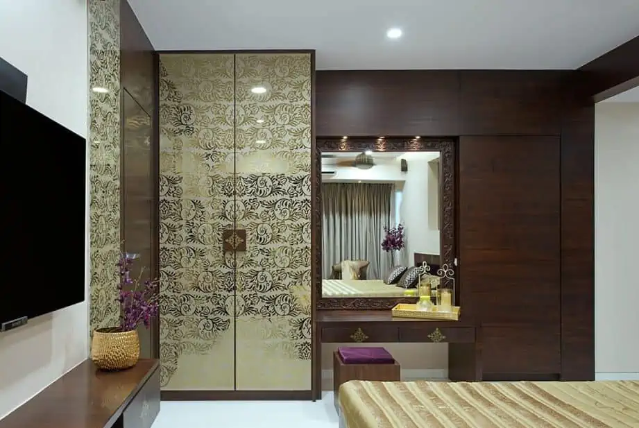 A beautiful brown color dresser attached to a wardrobe in a small bedroom.