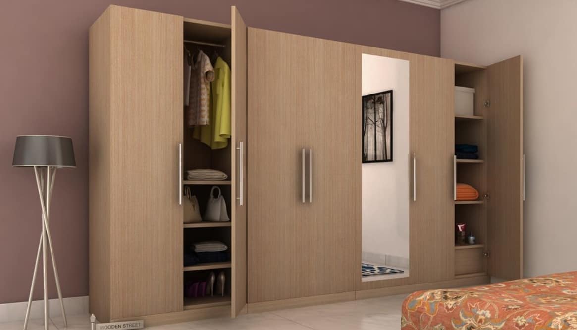 a brown wooden closet with clothes