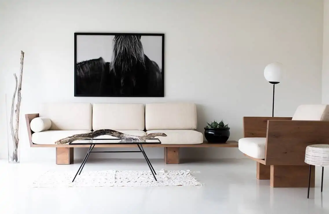 white living room with white sofa, painting and a table