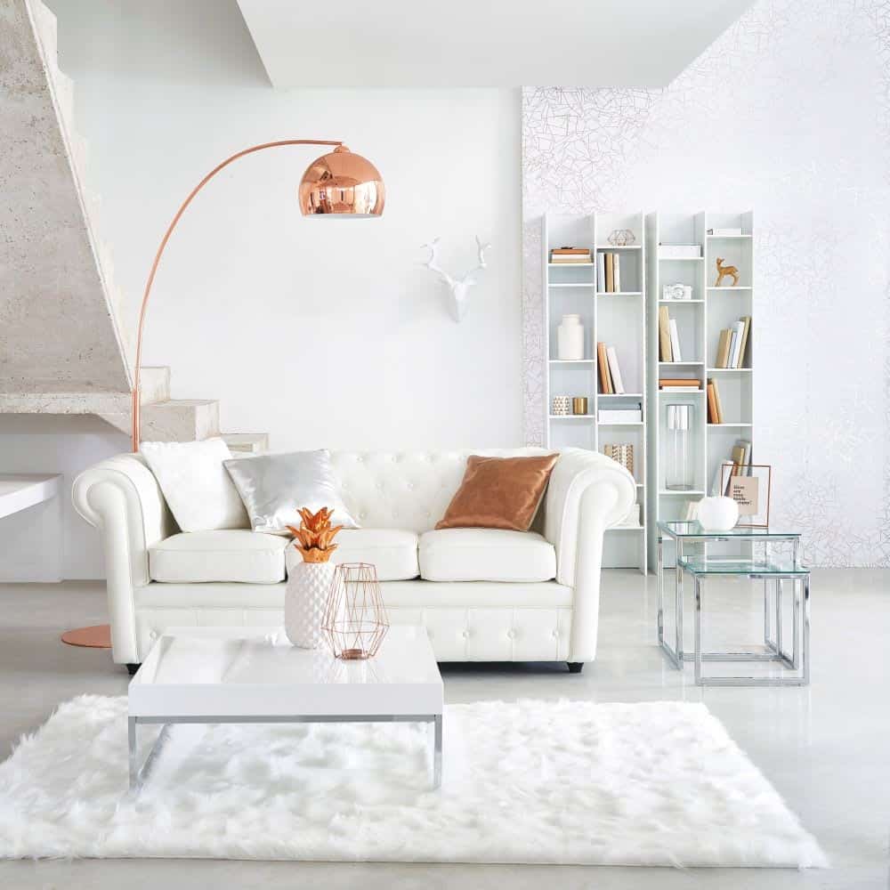 white living room interiors with white sofa, table, rug and accent golden lamp