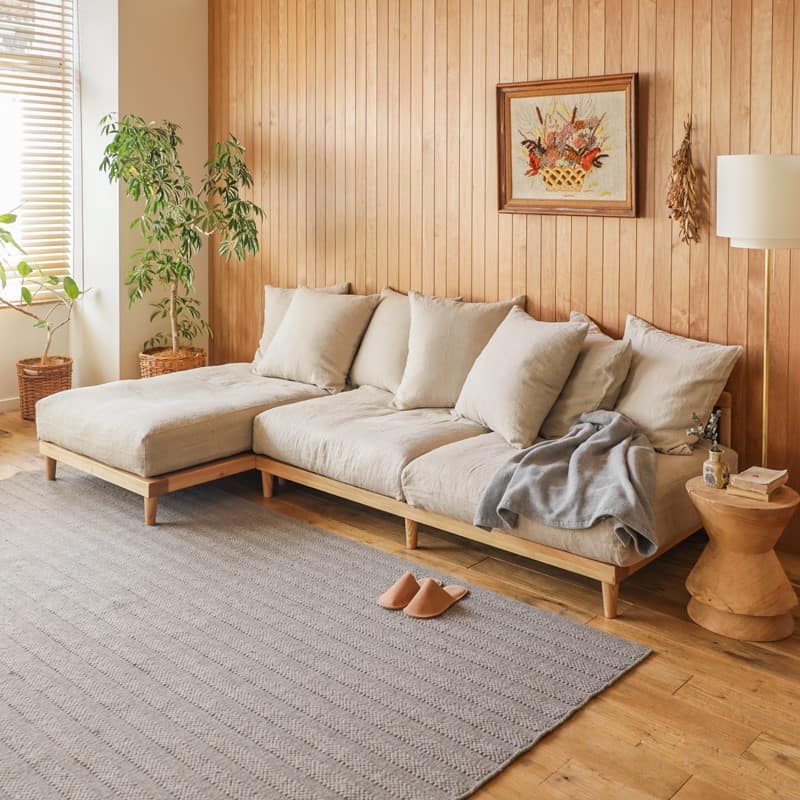 light brown walls oin a living room with grey rug and a sofa