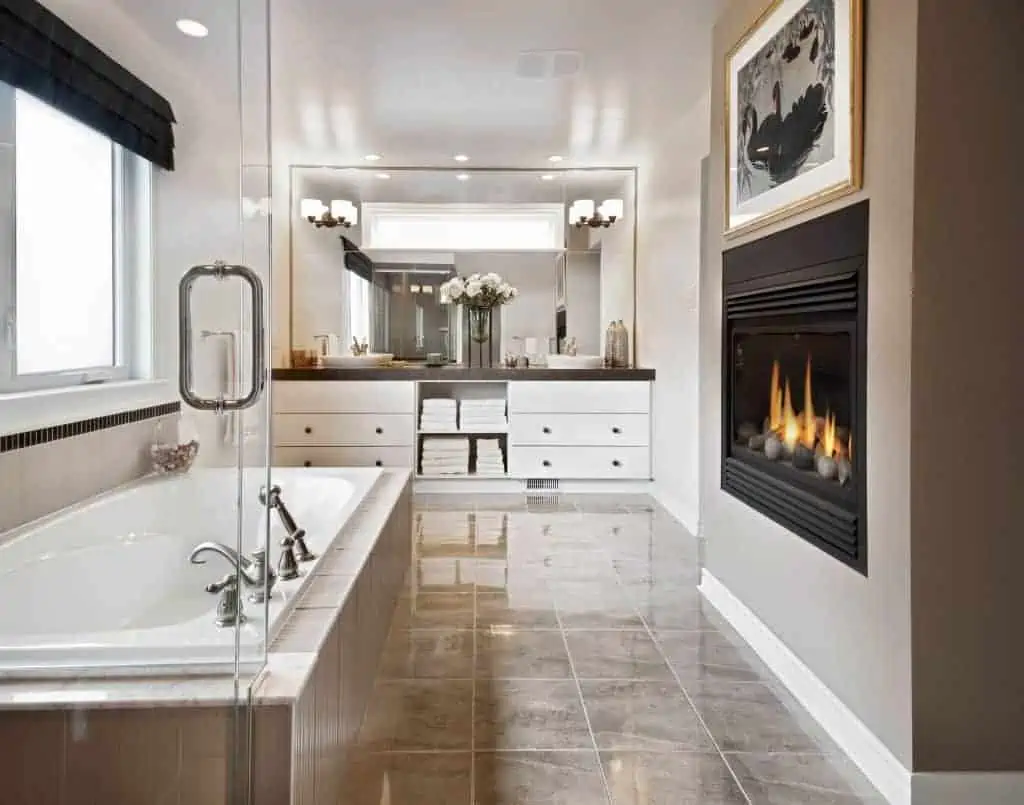 Alcove built in bathtub in luxurious bathroom with cream tiles