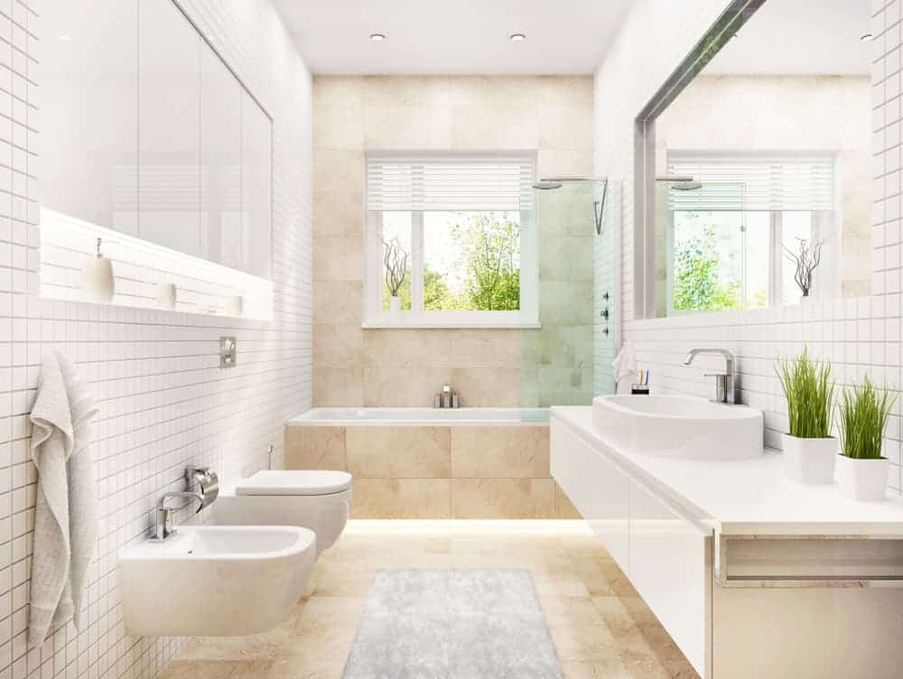 Alcove built in bathtub in luxurious bathroom with cream tiles