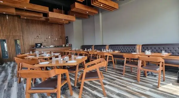 Celesto Bar & Restaurant interiors with wooden furniture made from canadian wood species by minimal stroke & wings design studio - top design firms in indian hospitality sector