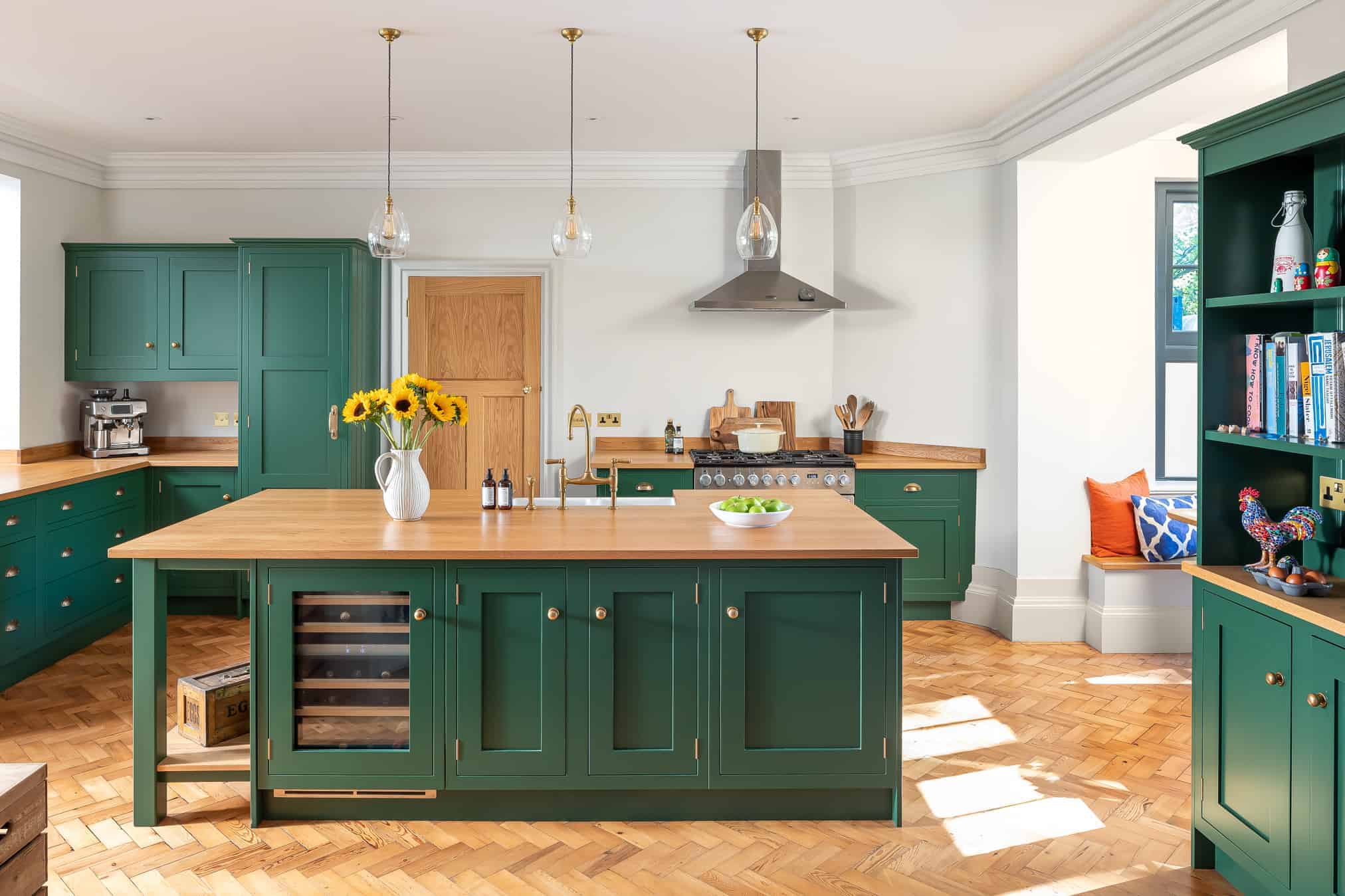 A colourful kitchen with green kitchen cabinets.