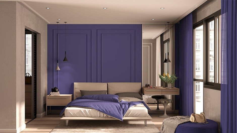 purple walls in a bedroom with bed, table and light