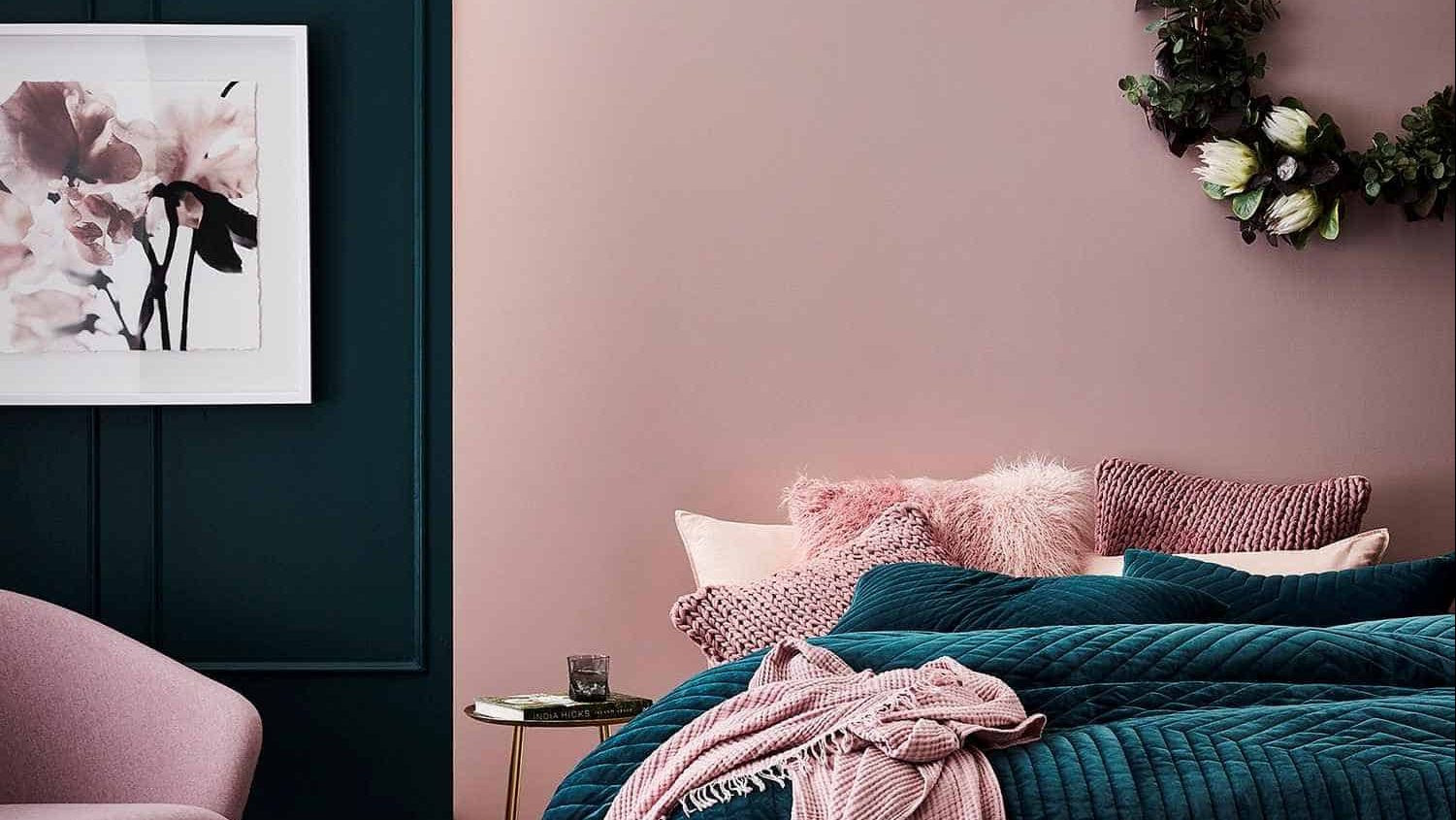 pink and blue wall paint with bed, chair and painting