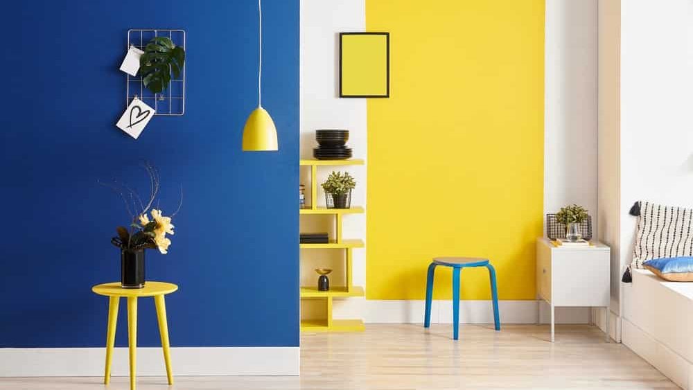 blue and yellow wall paint in a hall with table and lamp colour combination for bed room, living room, drawing room and hall walls