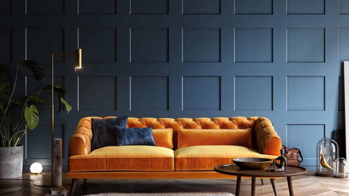 orange sofa in a lving room with rug