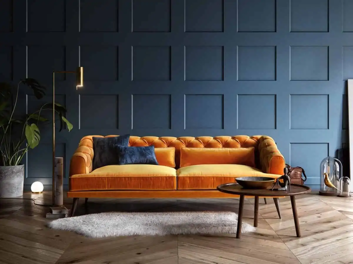 orange sofa in a lving room with rug