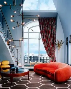 red couch in a living room with blue walls and a table