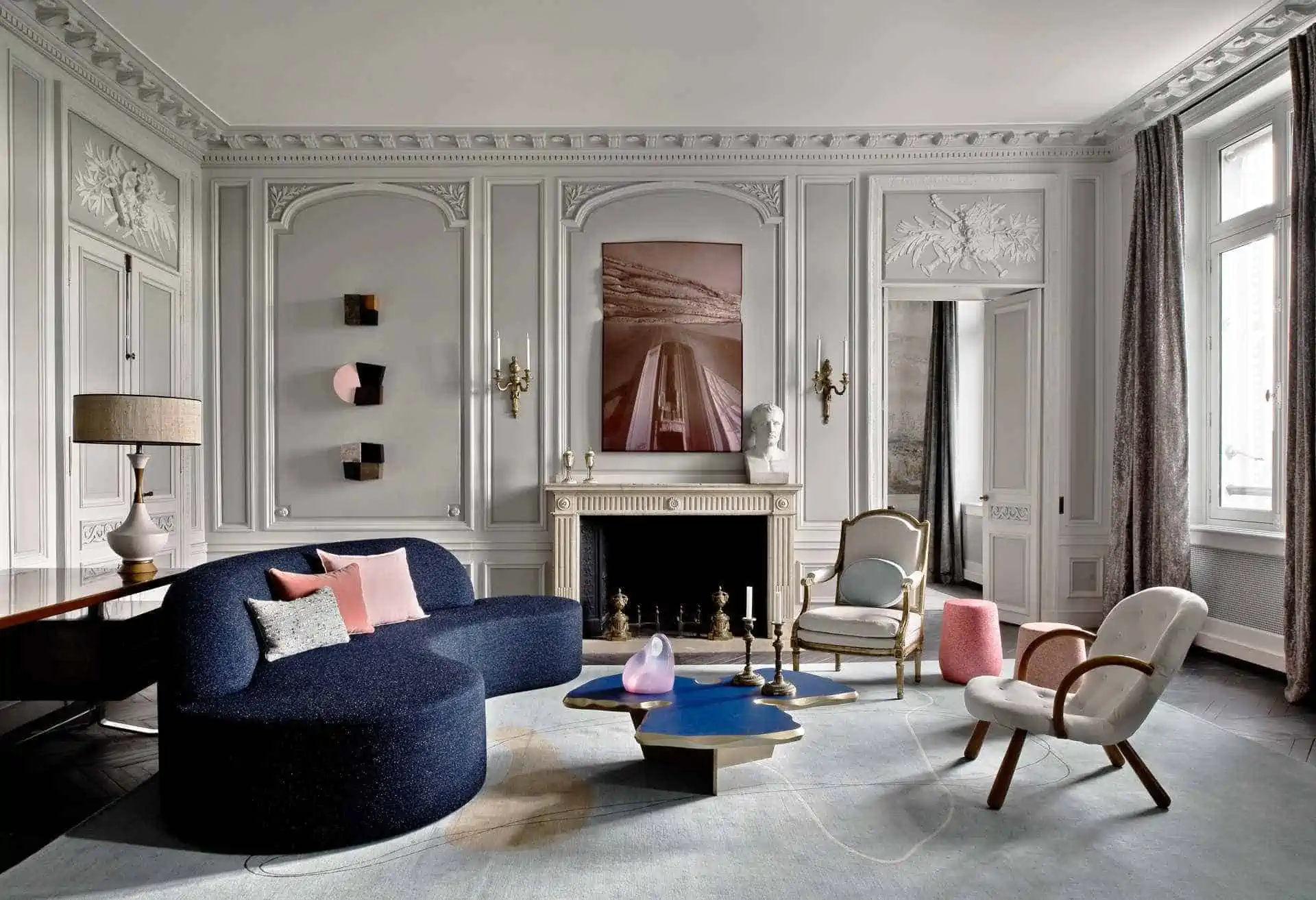 blue sofa in a living room with table, chair, fireplace