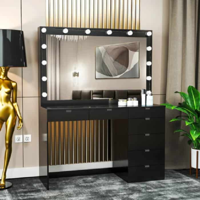 black vanity with lights and golden detailing with black and gold abstract floor lamp